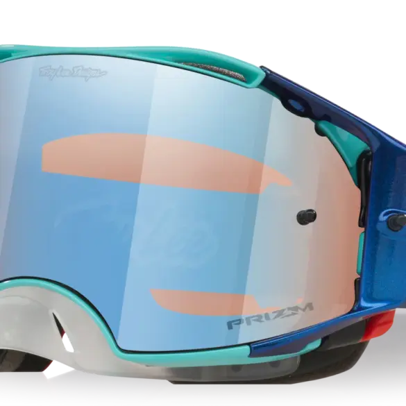 Oakley Airbrake MX Troy Lee Designs White Blue Stars mit reflektierendem Prizm MX Low Light Glas und verstellbarem, rot-blau gemustertem Band.