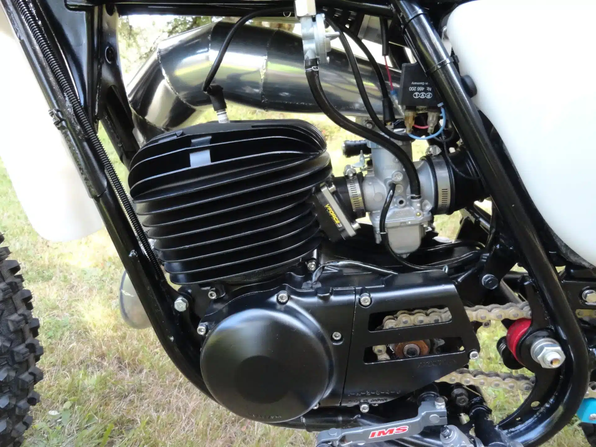 Motoransicht der 1976 Yamaha YZ250C mit zentralem Monocross-Heck und Aluminiumtank.