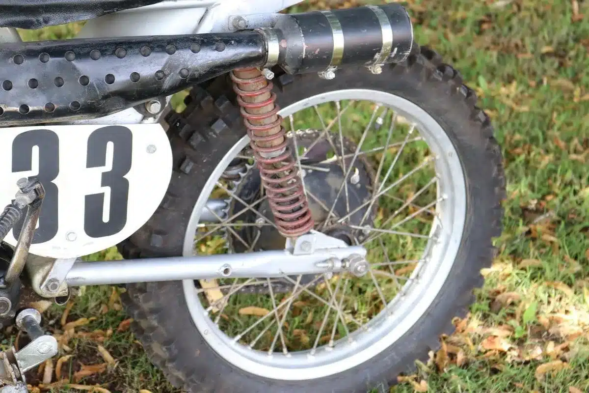 Twin-Shock-Hinterradfederung und Stollenreifen einer Husqvarna 250 Cross von 1967 mit Startnummer 33