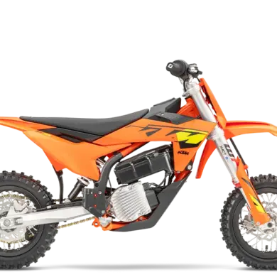 Seitenansicht einer KTM SX-E 3 2025, orangefarbenes elektrisches Kinder-Motocross-Motorrad auf weißem Hintergrund