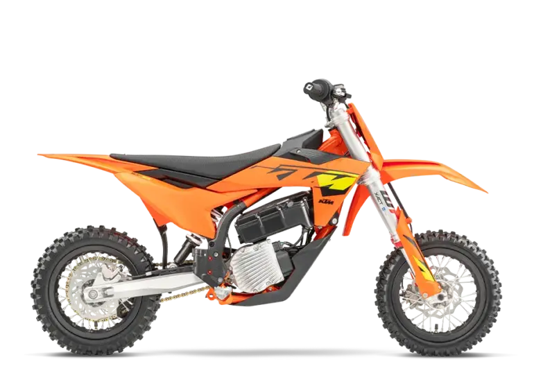 Seitenansicht einer KTM SX-E 3 2025, orangefarbenes elektrisches Kinder-Motocross-Motorrad auf weißem Hintergrund