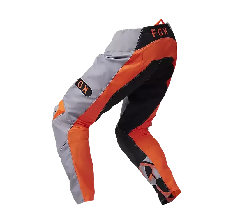 FOX 180 Emotion Crosshose in orange-grauer Farbkombination mit schwarzen Akzenten, seitliche Ansicht.