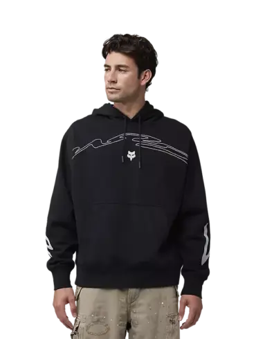 Mann trägt den Fox Racing Kapuzenpullover Energy Face Oversized in Schwarz mit weißer Grafik und Kängurutasche.