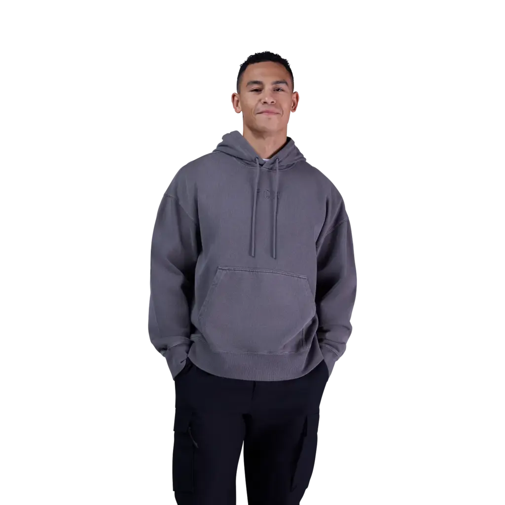 Person trägt einen grauen, oversized geschnittenen Kapuzenpullover von Fox Racing mit Kängurutasche und dezentem Sticklogo.