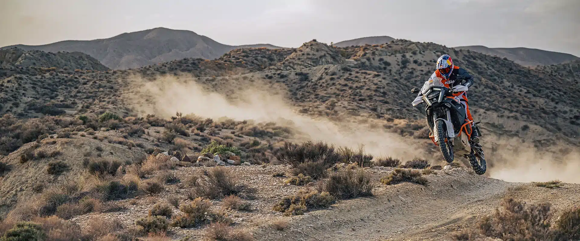 KTM 1390 Super Adventure R wird von einem Fahrer im Offroad-Modus durch steiniges Gelände gefahren.