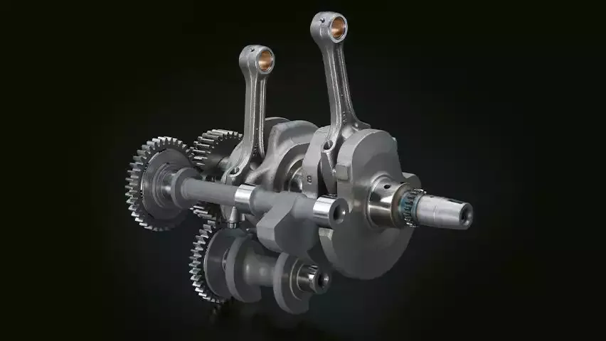 Kurbelwelle und Pleuelstangen des Parallel-Twin-Motors der Suzuki V-Strom 800DE, Nahaufnahme auf schwarzem Hintergrund.