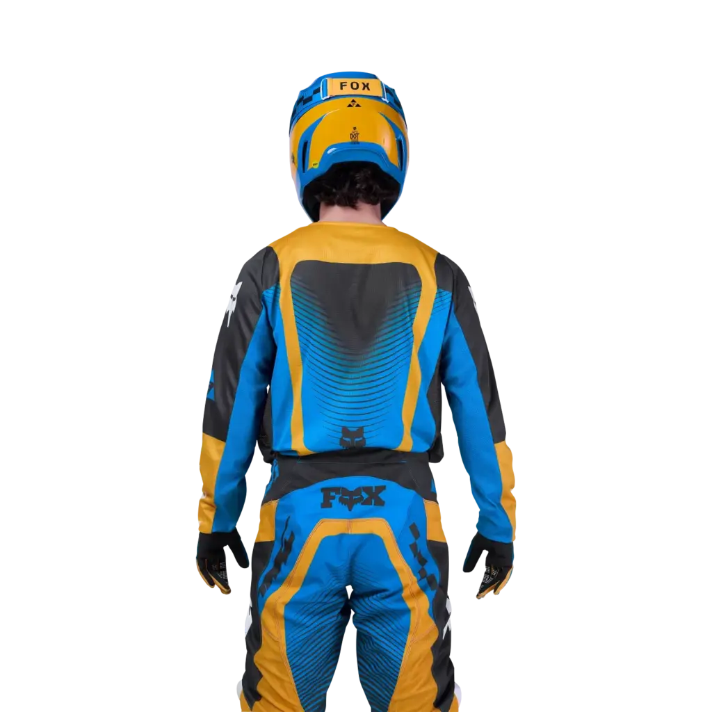Motocross-Fahrer von hinten im gelb-blauen FOX 180 Collect Jersey mit Drop-Tail-Design und abgestimmtem Helm.