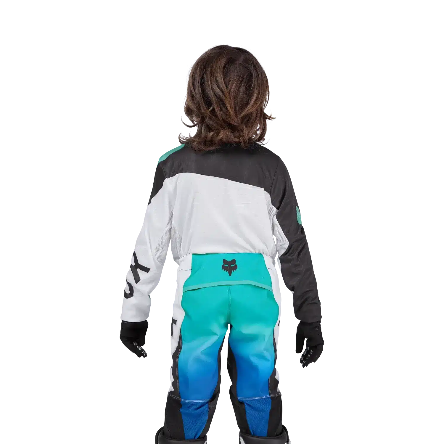 Kind in kompletter Flexair Spire Jersey Motocross-Ausrüstung von hinten, mit Fox-Logo, weißen und türkisen Farbakzenten.