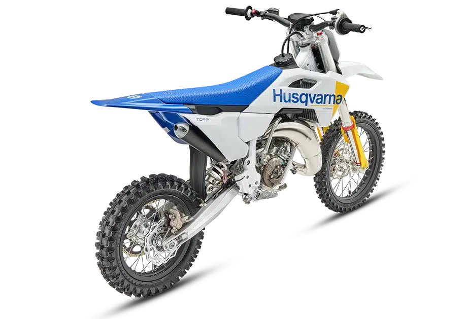 Husqvarna TC 65 2027 Kinder-Motocross-Motorrad in weiß-blau-gelb, Seitenansicht mit Stollenreifen
