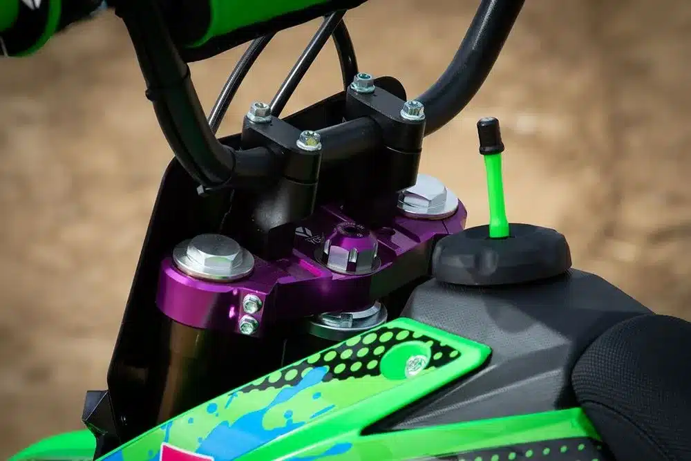 Detailansicht des violetten Lenkkopfes, der bronzefarbenen Gabelholme und des grünen Tankbereichs der YCF Pilot 150 Limited Green