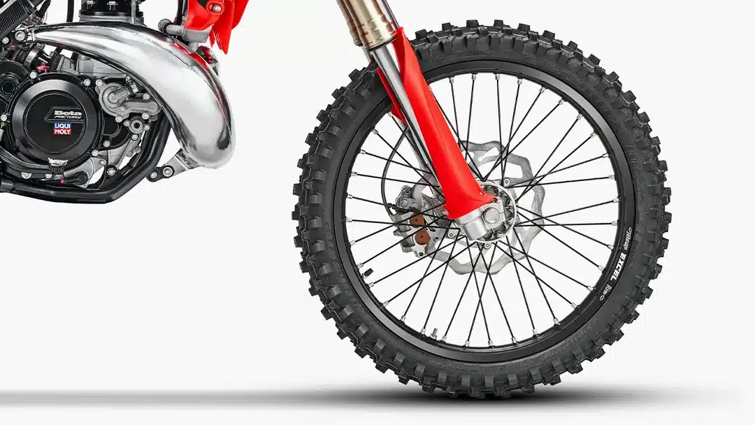 Nahaufnahme des Vorderrads und Motors der Beta RX 2T 350 mit grobstolligem Reifen und markanter Upside-down-Gabel