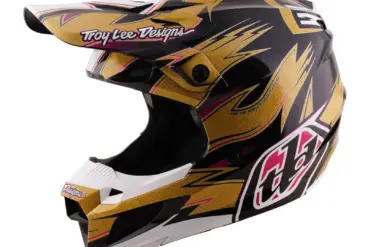 Motocross-Helm Troy Lee Designs in Gold-Schwarz mit integriertem Kinnbügel und Visier