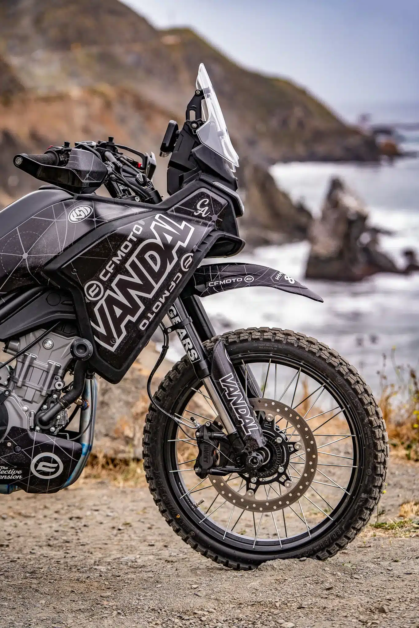 CFMOTO VANDAL 2 Adventure-Bike mit Offroad-Reifen und markanter Frontansicht vor felsiger Küstenlandschaft