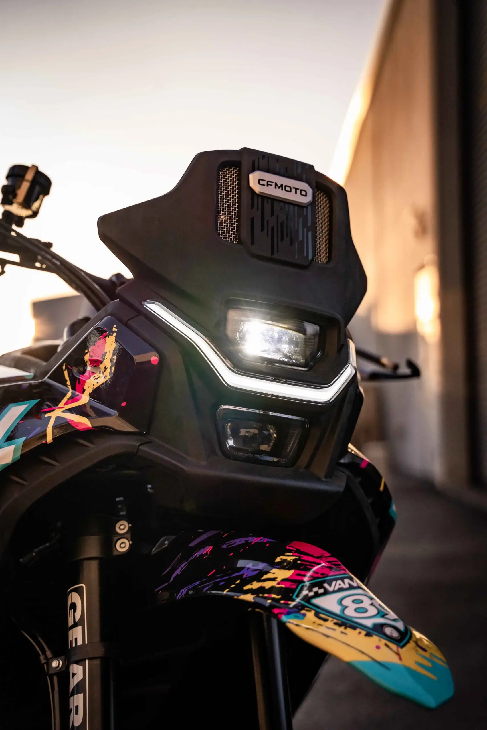 Frontpartie der CFMOTO Ibex 450 Vandal Supermoto mit LED-Scheinwerfer und buntem Vorderradkotflügel
