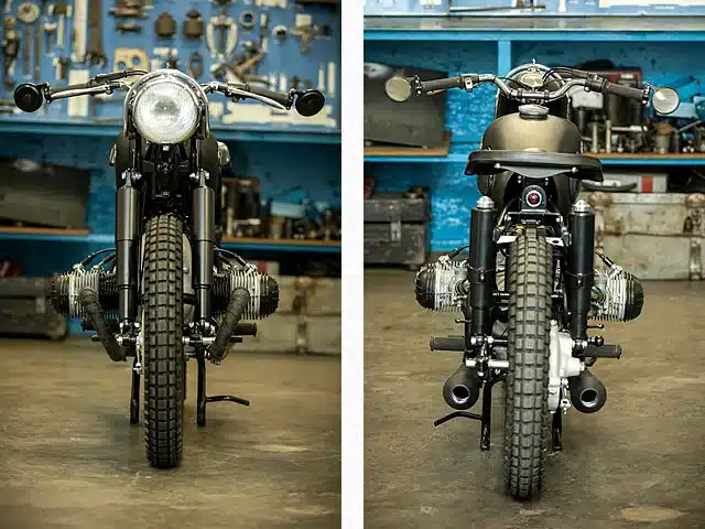 Restaurierte BMW R50 von 1955, Vorder- und Rückansicht in einer Werkstatt, klassisches Motorrad mit schwarzen Anbauteilen